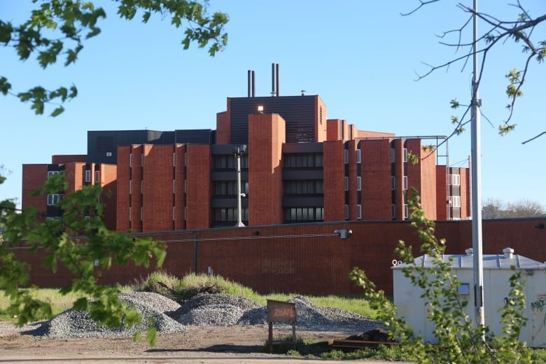 An industrial-looking brick building on a sunny day.