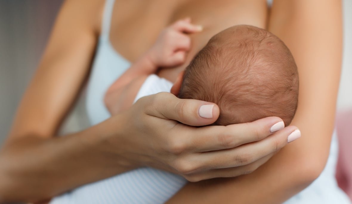 Baby in woman's arms