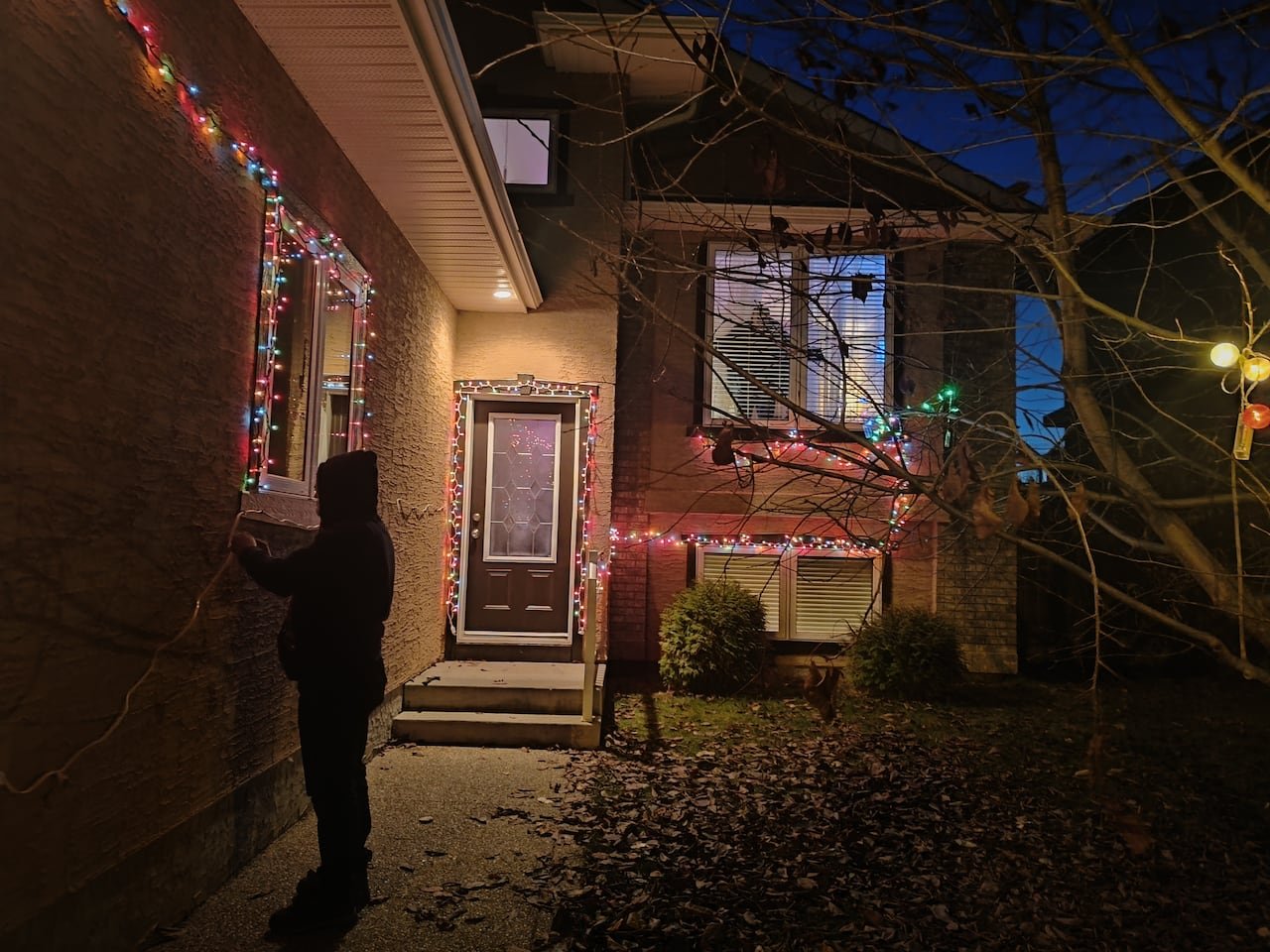default-438 Lights sparkle on the edges of a house lit at night.